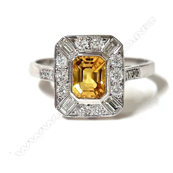 A lady's 18ct. yellow sapphire and diamond cluster ring in the Art Deco manner