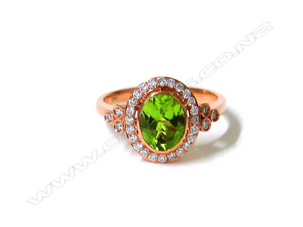 A lady's modern 18ct. rose gold peridot and diamond cluster ring Image 1++