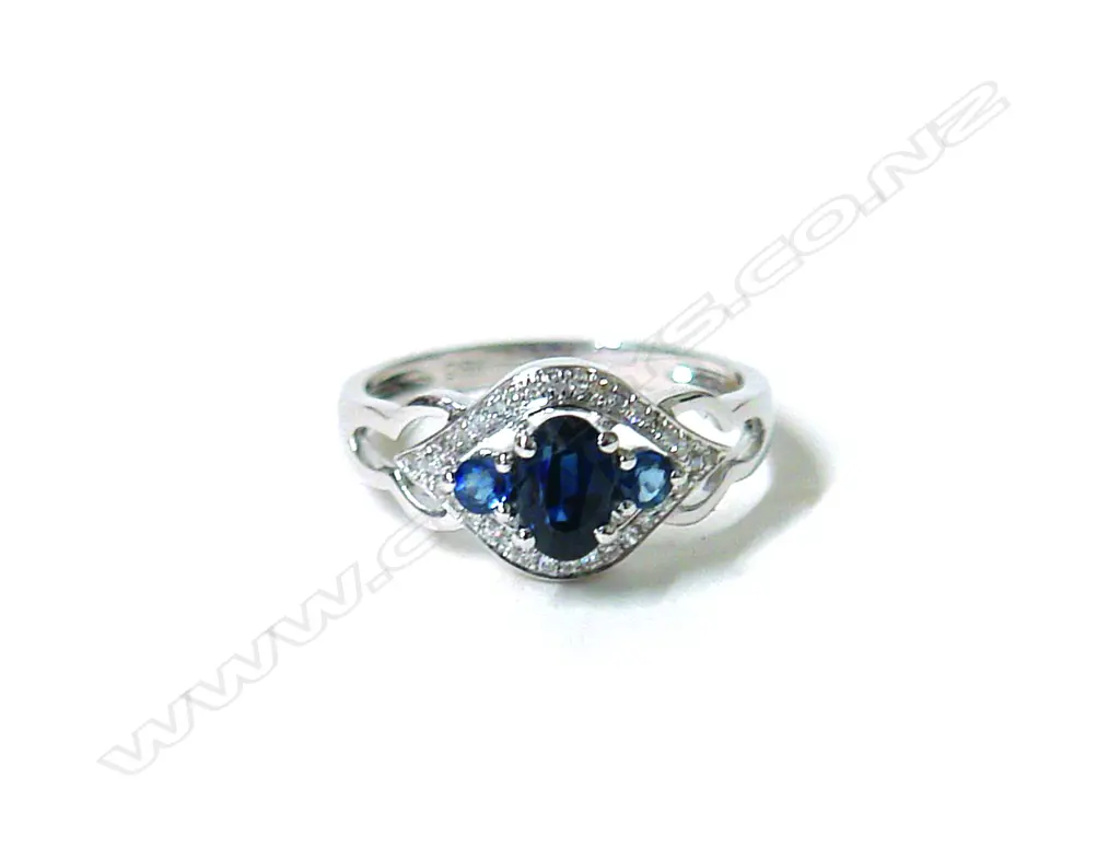 A lady's modern 18ct. white gold sapphire and diamond cluster ring Image 1++