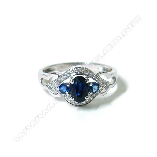 A lady's modern 18ct. white gold sapphire and diamond cluster ring