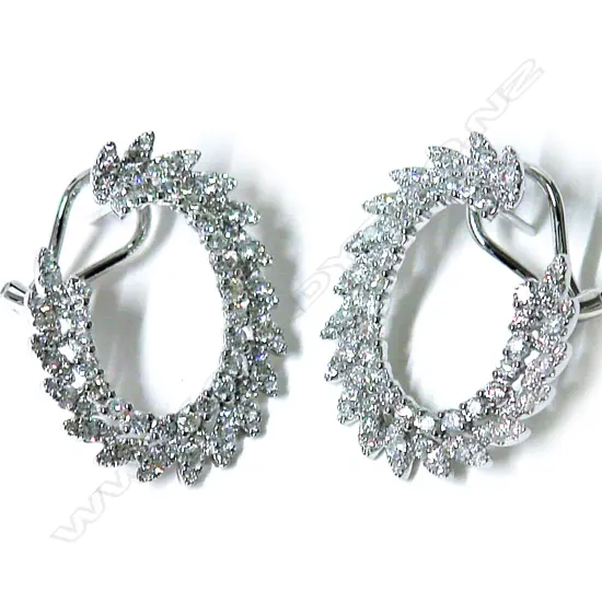 A pair of lady's modern 18ct. white gold and diamond three-quarter hoop earrings