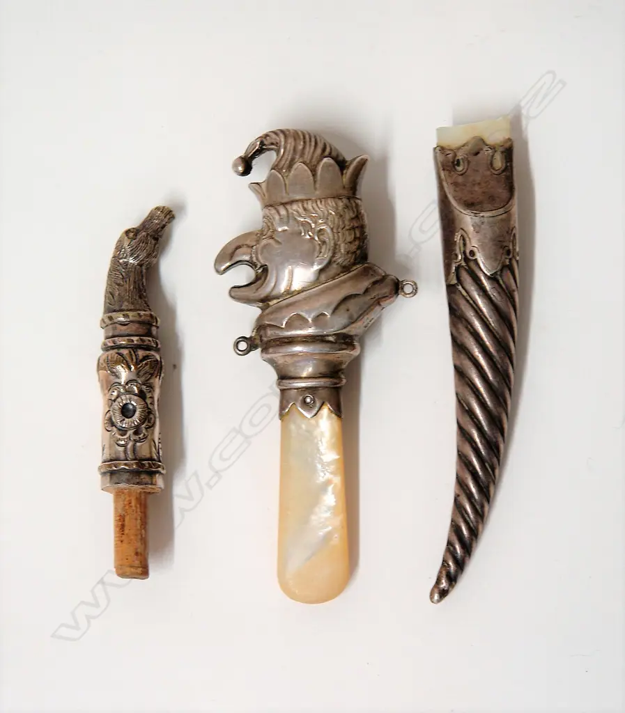 A silver and M.O.P. Punch teething ring and two other items Image 1++