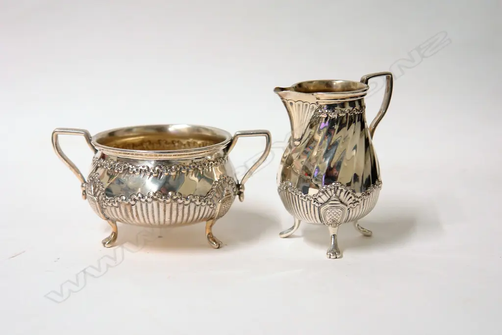 A pair of late Victorian silver Chippendale style sugar and cream Image 1++