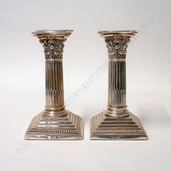 A pair of Edwardian silver Corinthian column candlesticks