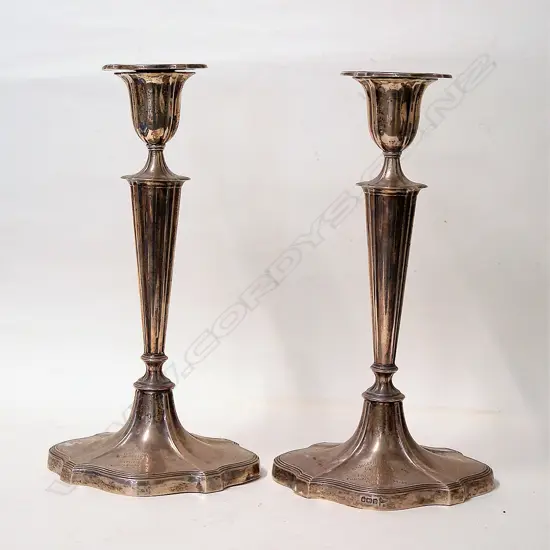 A pair of early 20thC tall silver tall column candlesticks with N.Z Military history