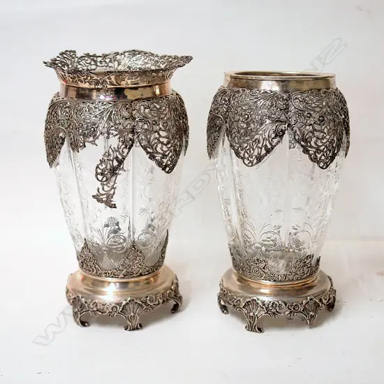 A pair of Edwardian elaborately silver mounted decorative glass vases