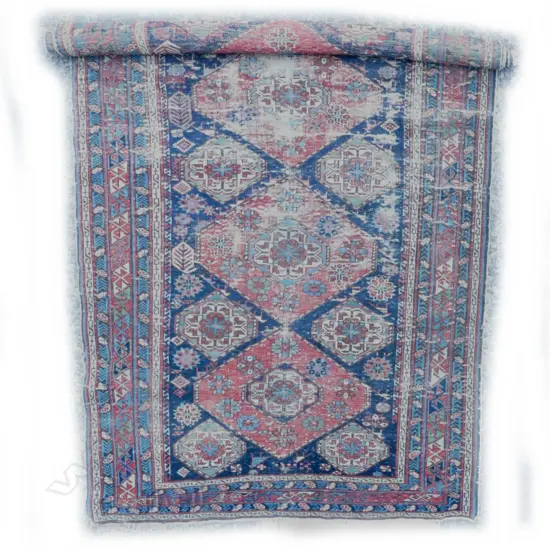 An old hand-knotted Caucasian rug