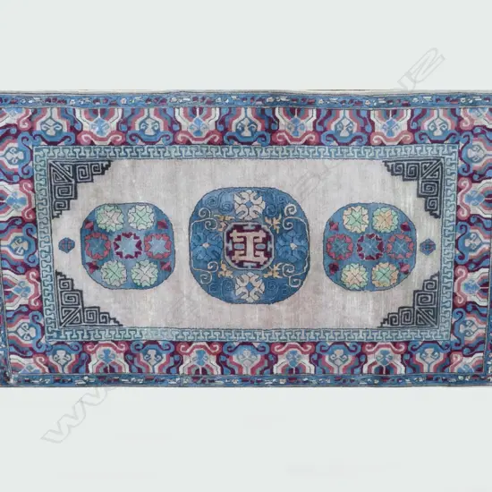 An old handmade Chinese wool rug