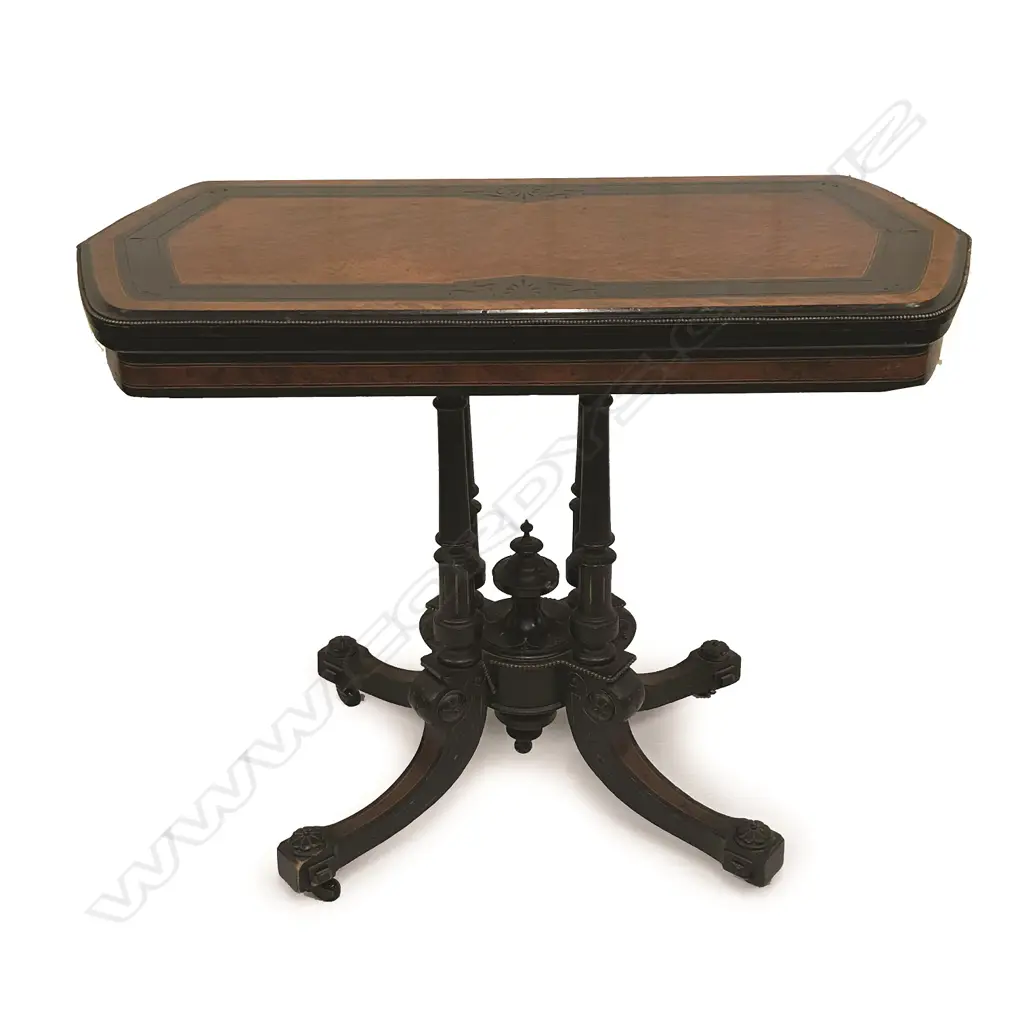 A Victorian birdseye maple and ebonized fold-over top games table Image 1++