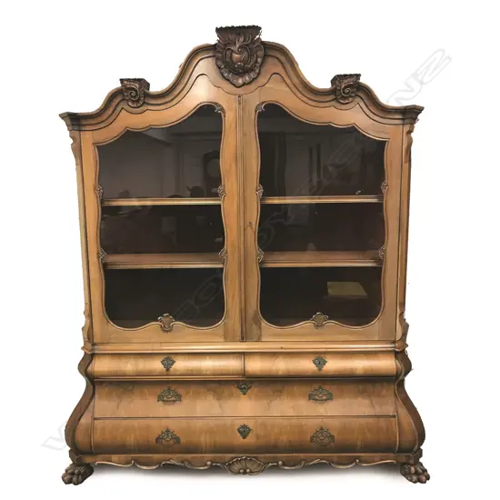 A large early 20thC European walnut display bombe cabinet