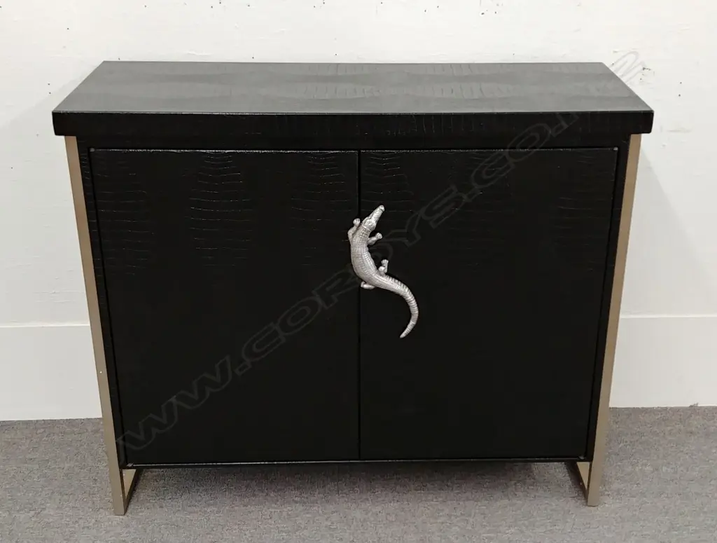 A stylish modern black 'crocodile skin' two door cabinet raised on two angular metal frames (one at each end) and a silvered metal crocodile handle Image 1++