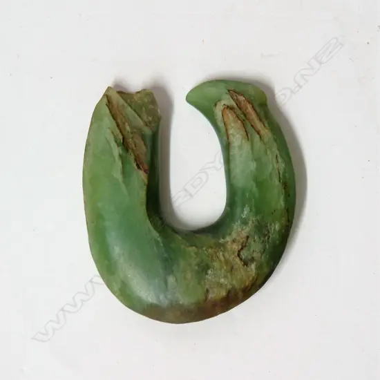 An old Maori pounamu matau (greenstone fish hook)