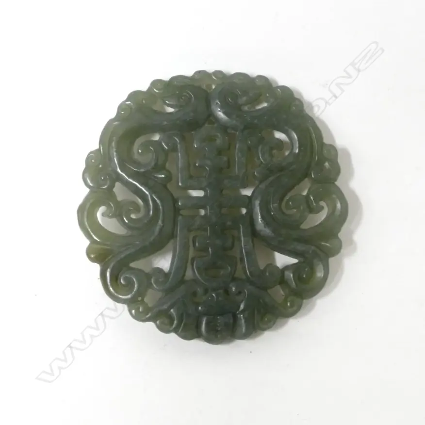A Chinese green jade circular tablet pendant Image 1++