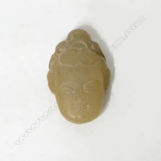 A Chinese pale brown jade pendant mask of Kuanyin