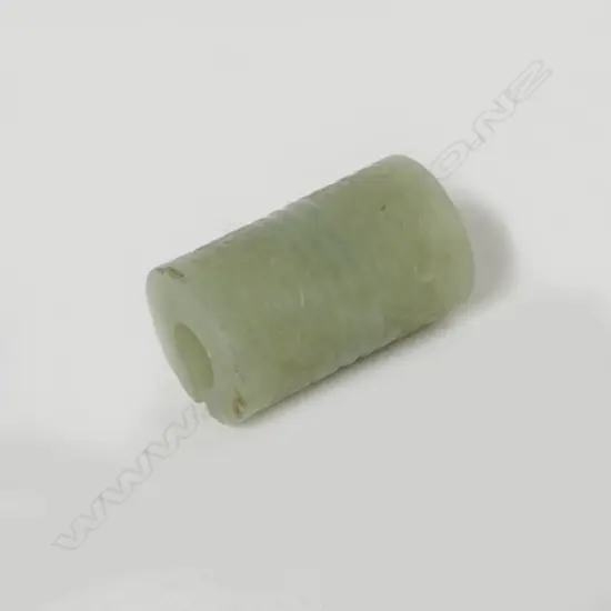 A Chinese pale green jade cylindrical bead