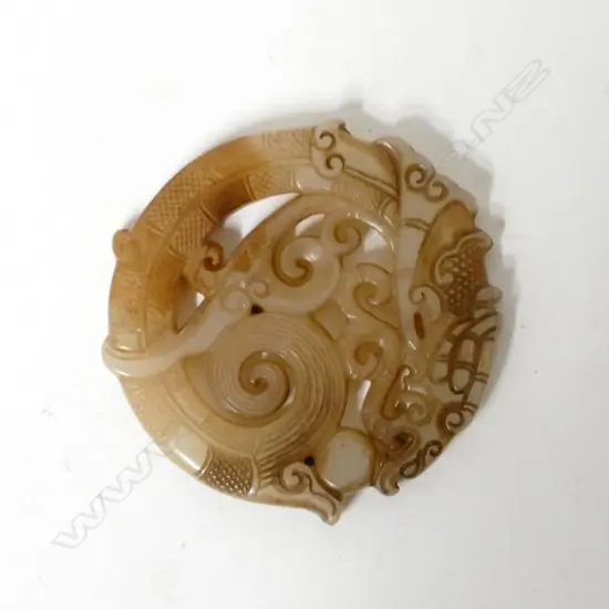A Chinese pale jade circular disc