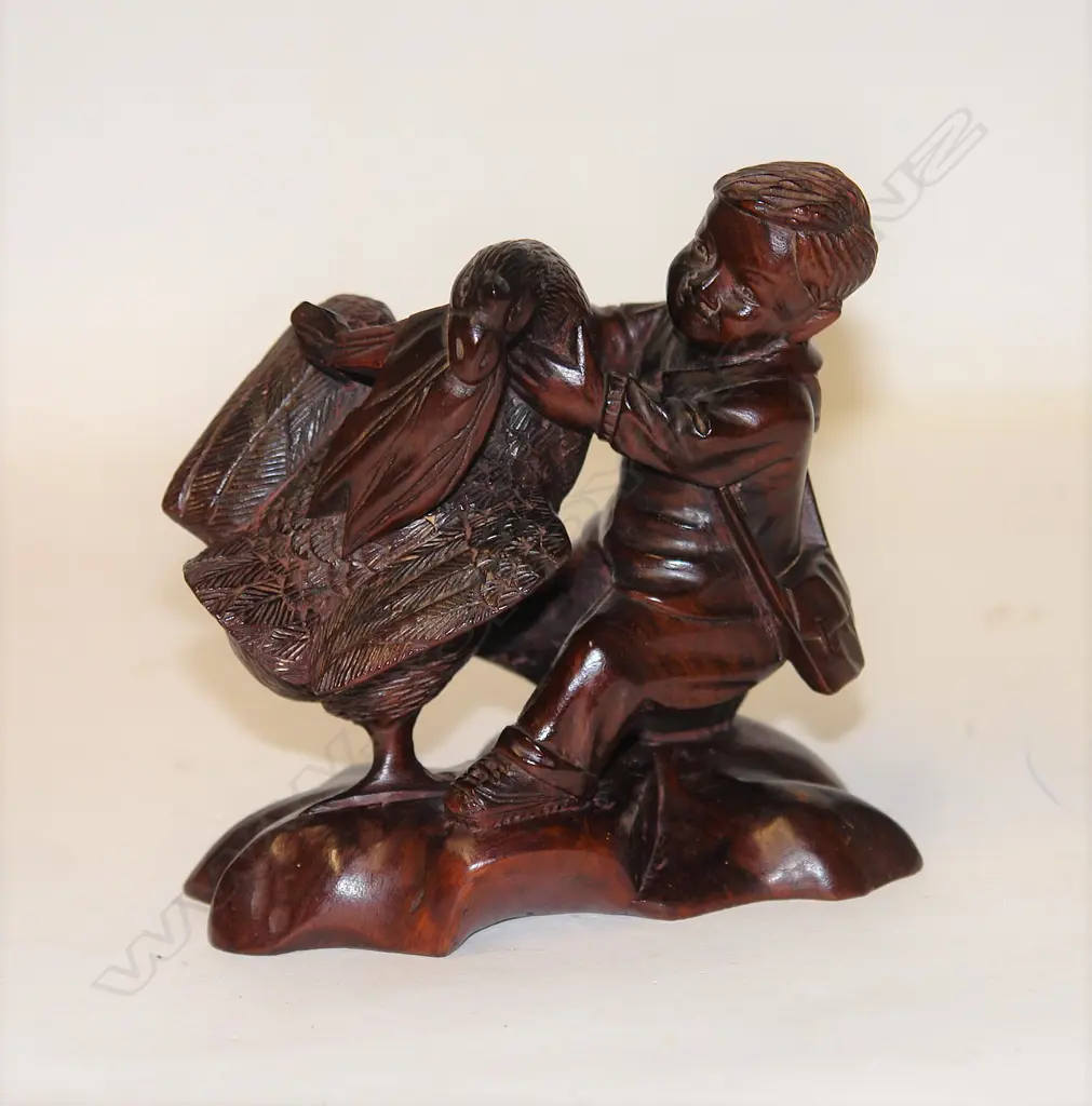 A Chinese carved hardwood Communist Maoist era figure of a young boy with a large bird Image 1++