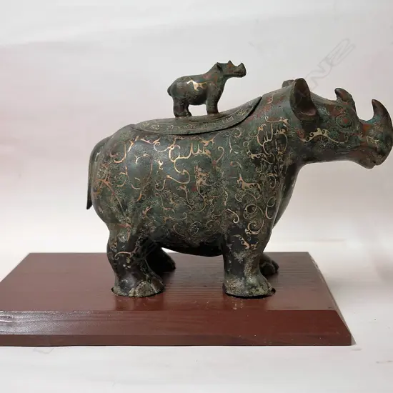 A Chinese archaic style bronze rhinoceros lidded vessel