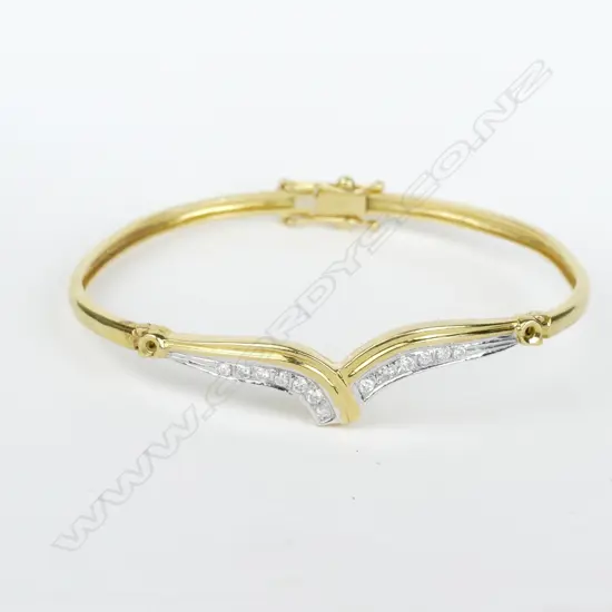 An 18ct gold and diamond necklace and bangle