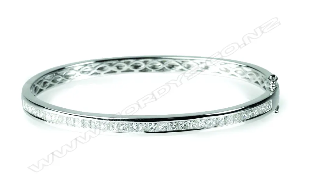 A modern 18ct. white gold and diamond hinged bangle Image 1++