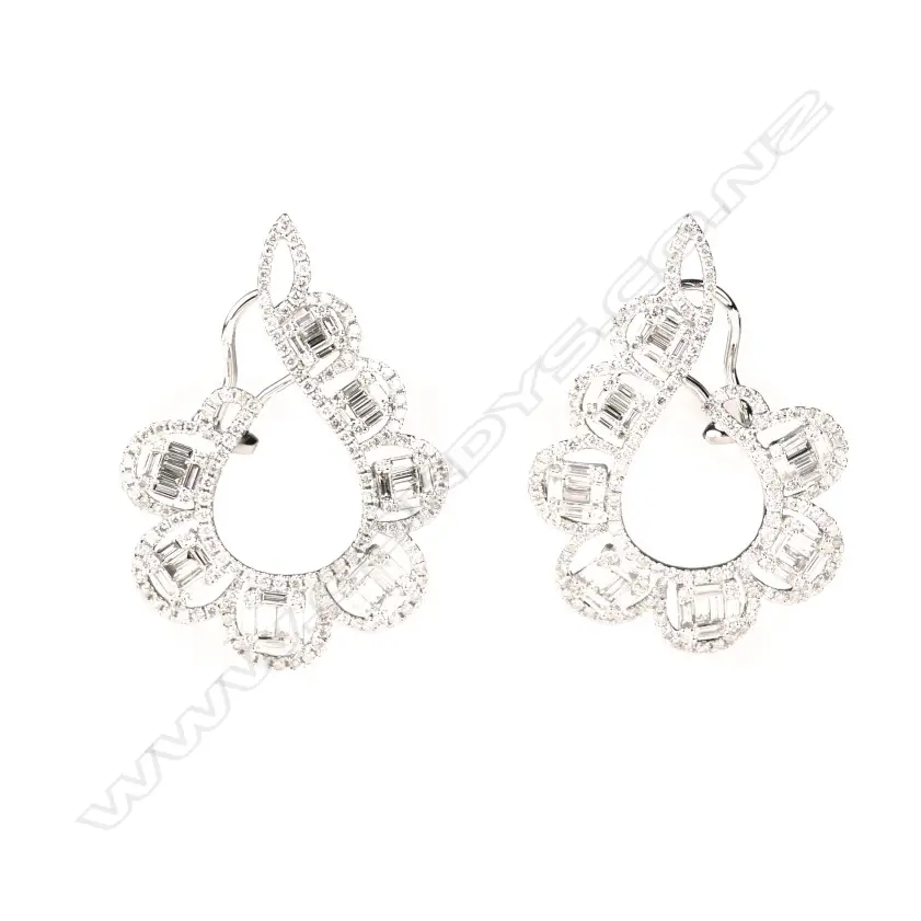 A pair of modern 18ct. white gold and diamond cluster scroll earrings Image 1++