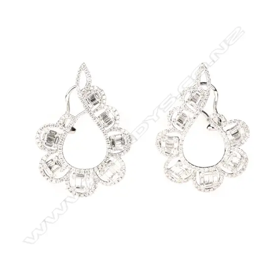 A pair of modern 18ct. white gold and diamond cluster scroll earrings