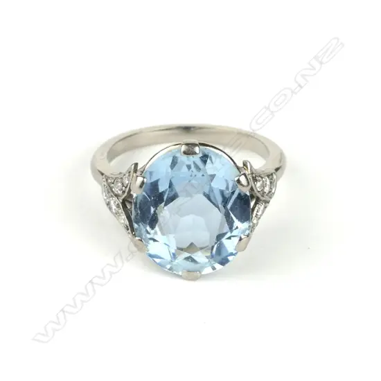 An 18ct. white gold aquamarine and diamond ring