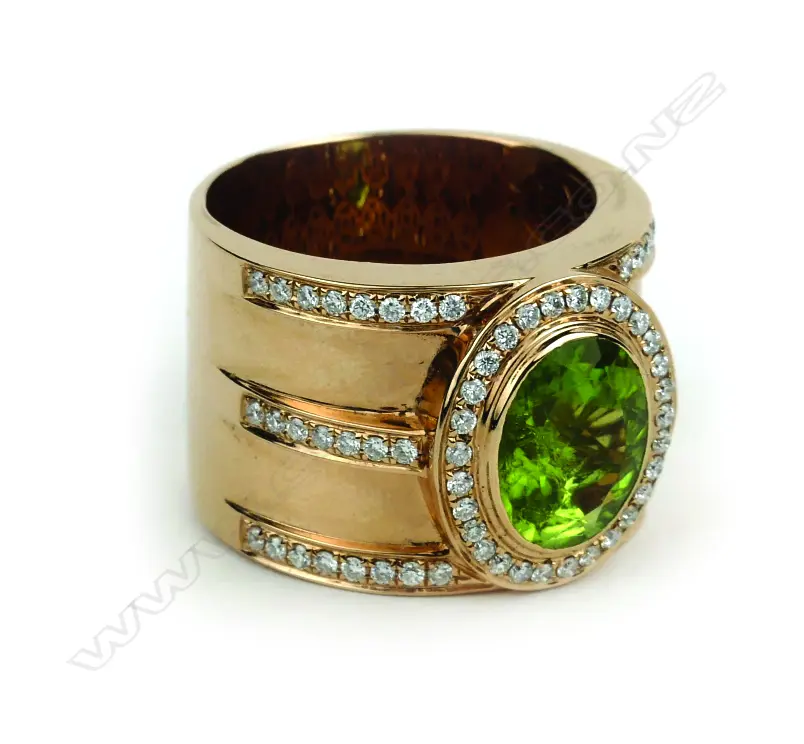 An 18ct. rose gold peridot and diamond dress ring Image 1++