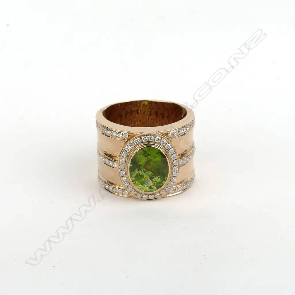 An 18ct. rose gold peridot and diamond dress ring Image 1++