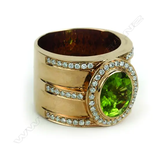 An 18ct. rose gold peridot and diamond dress ring