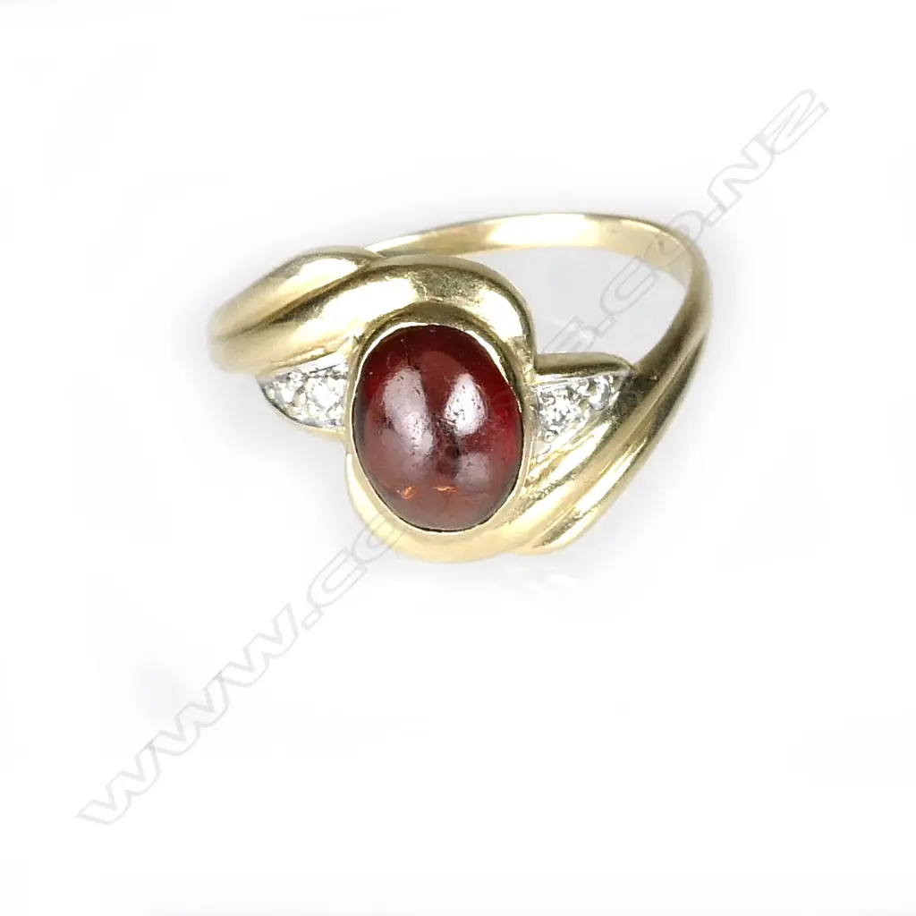 An 18ct. yellow gold garnet and diamond ring Image 1++