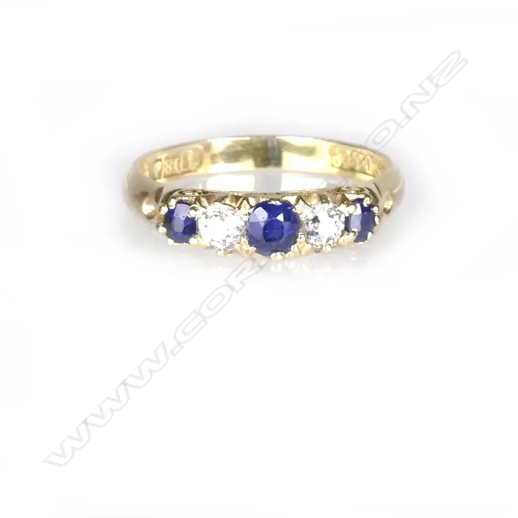 An 18ct. yellow gold natural sapphire and diamond bridge ring Image 1++