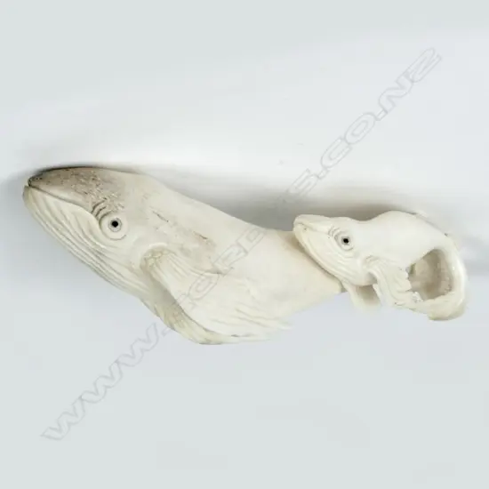 A small antler carving in the form of a mother blue whale mother and calf