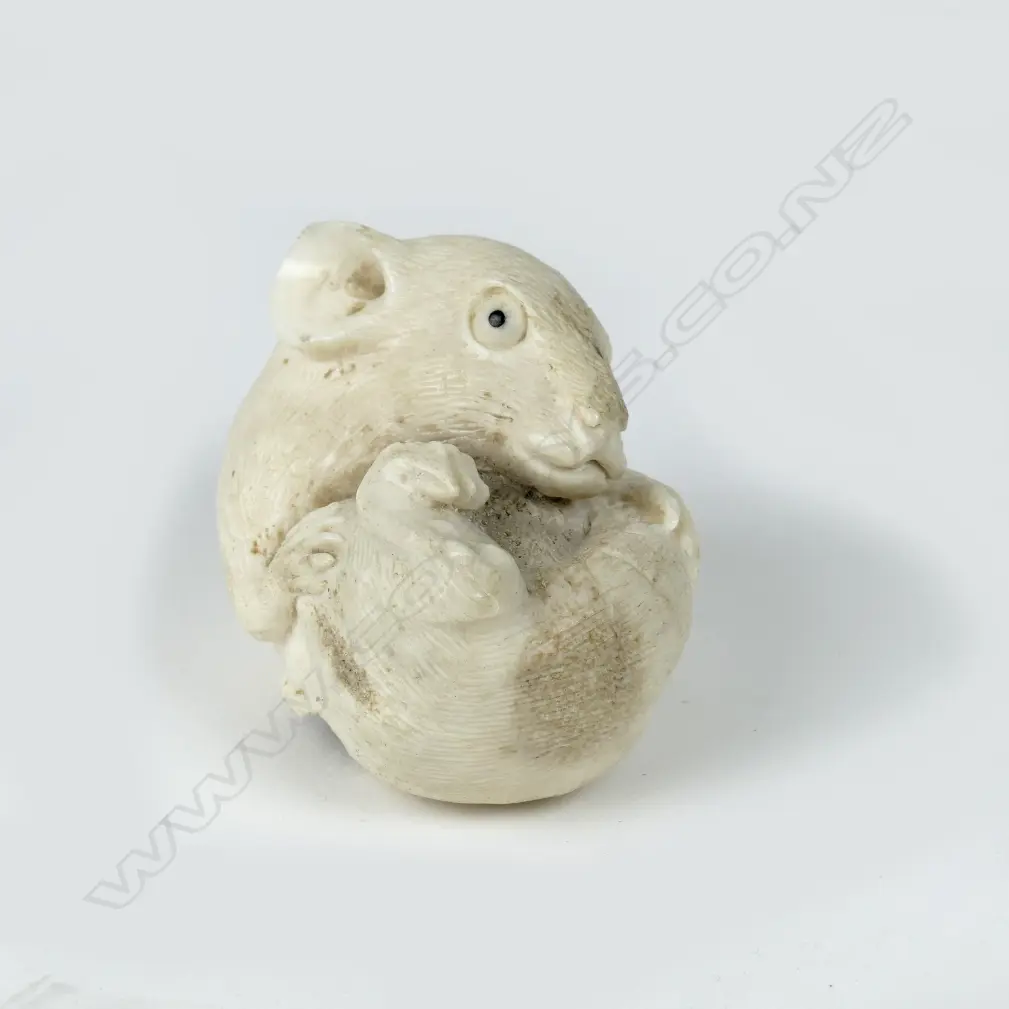A small antler carving in the form of a rat rolling on his back Image 1++