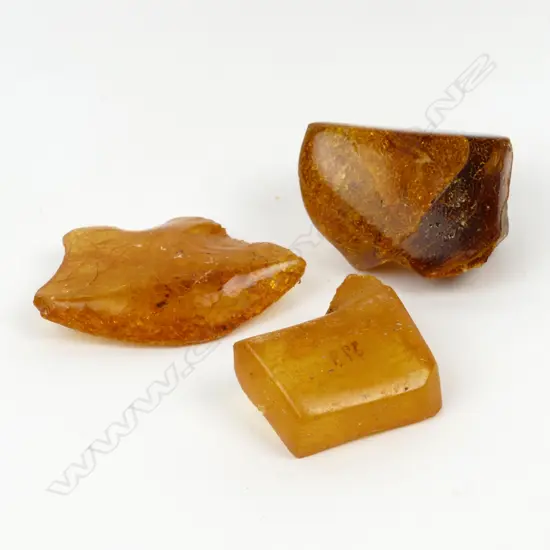 Three small polished kauri gum pieces