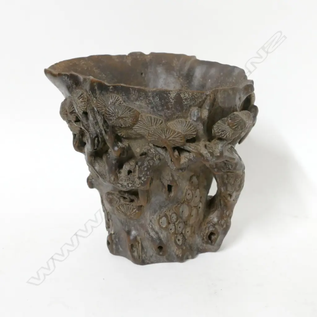 A carved centred wood libation cup Image 1++