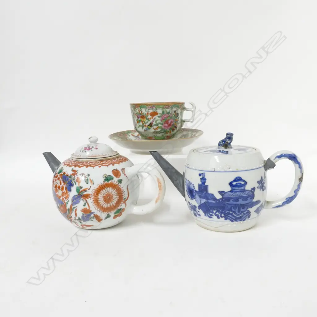 Two Chinese exportware porcelain teapots and a famille rose cup and saucer Image 1++