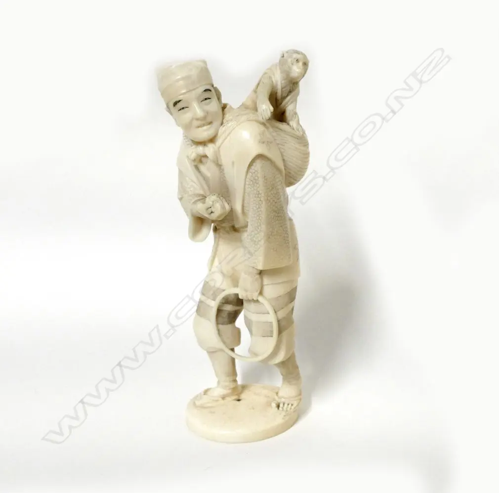 A Japanese carved ivory figure of a performer and tame monkey Image 1++