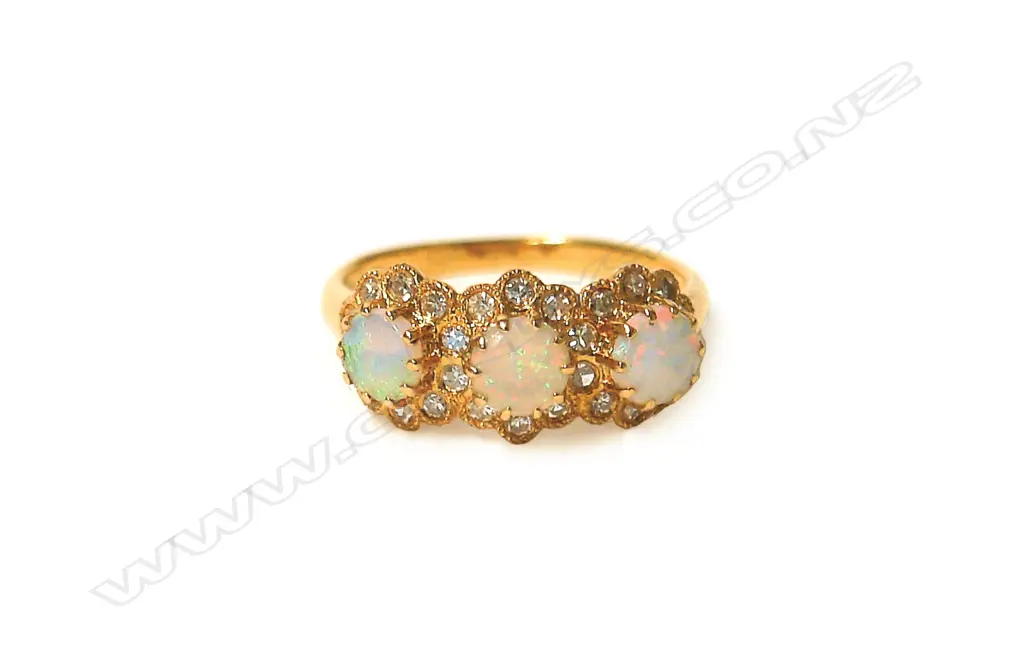 An 18ct. yellow gold opal and diamond cluster ring Image 1++