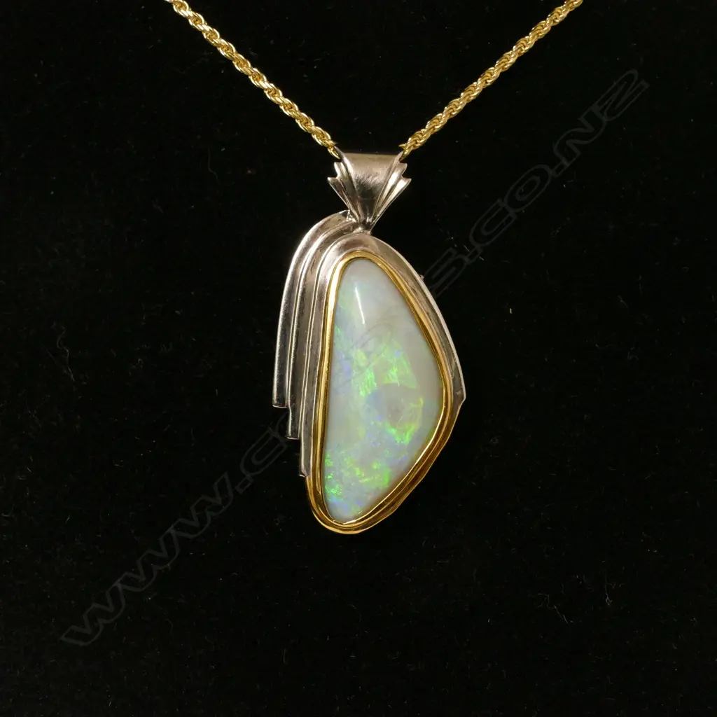 A 22ct. gold and silver set natural opal pendant Image 1++