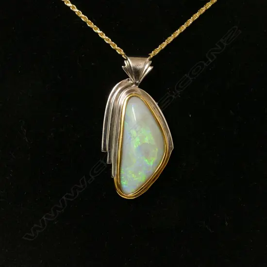A 22ct. gold and silver set natural opal pendant