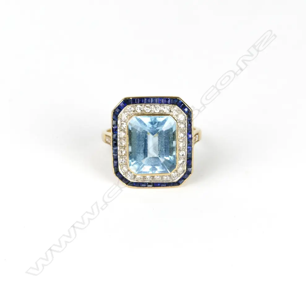An 18ct. gold aquamarine sapphire and diamond Deco style ring Image 1++