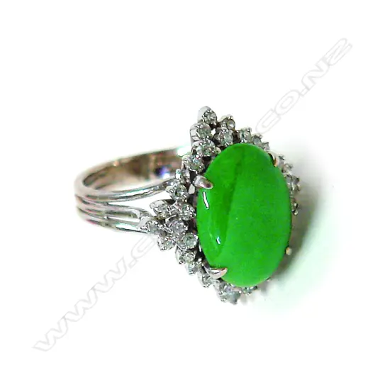 A modern 14ct.(approx.) white gold jadeite and diamond cluster ring