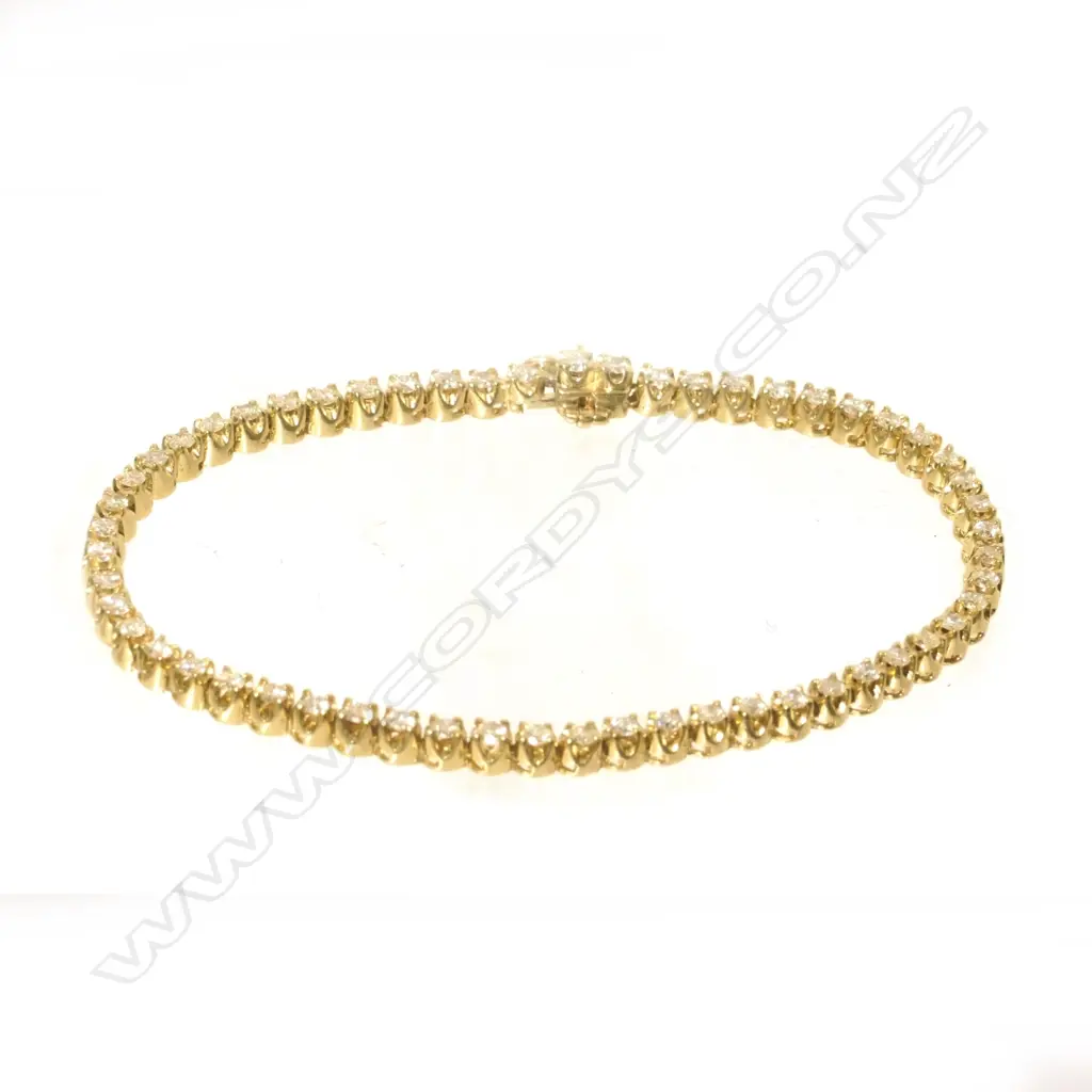A 9ct yellow gold tennis bracelet set with 56 round brilliant cut diamonds Image 1++