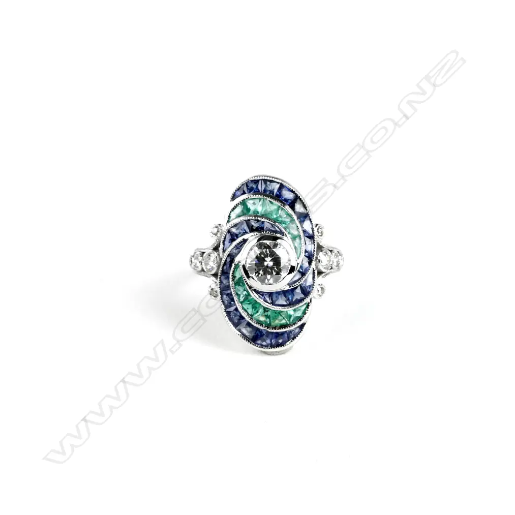 An 18ct. white gold emerald sapphire and diamond dress ring Image 1++