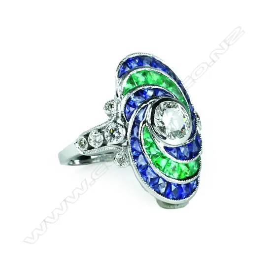 An 18ct. white gold emerald sapphire and diamond dress ring