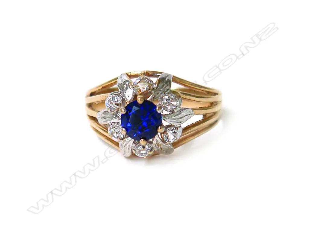 An 18ct. yellow gold sapphire and diamond cluster ring Image 1++