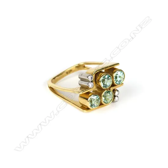 A retro 18ct. gold diamond and green gemstone ring