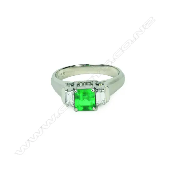 A platinum emerald and diamond ring
