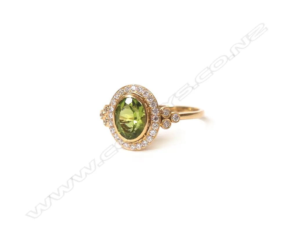 A 19ct. yellow gold peridot and diamond dress ring Image 1++